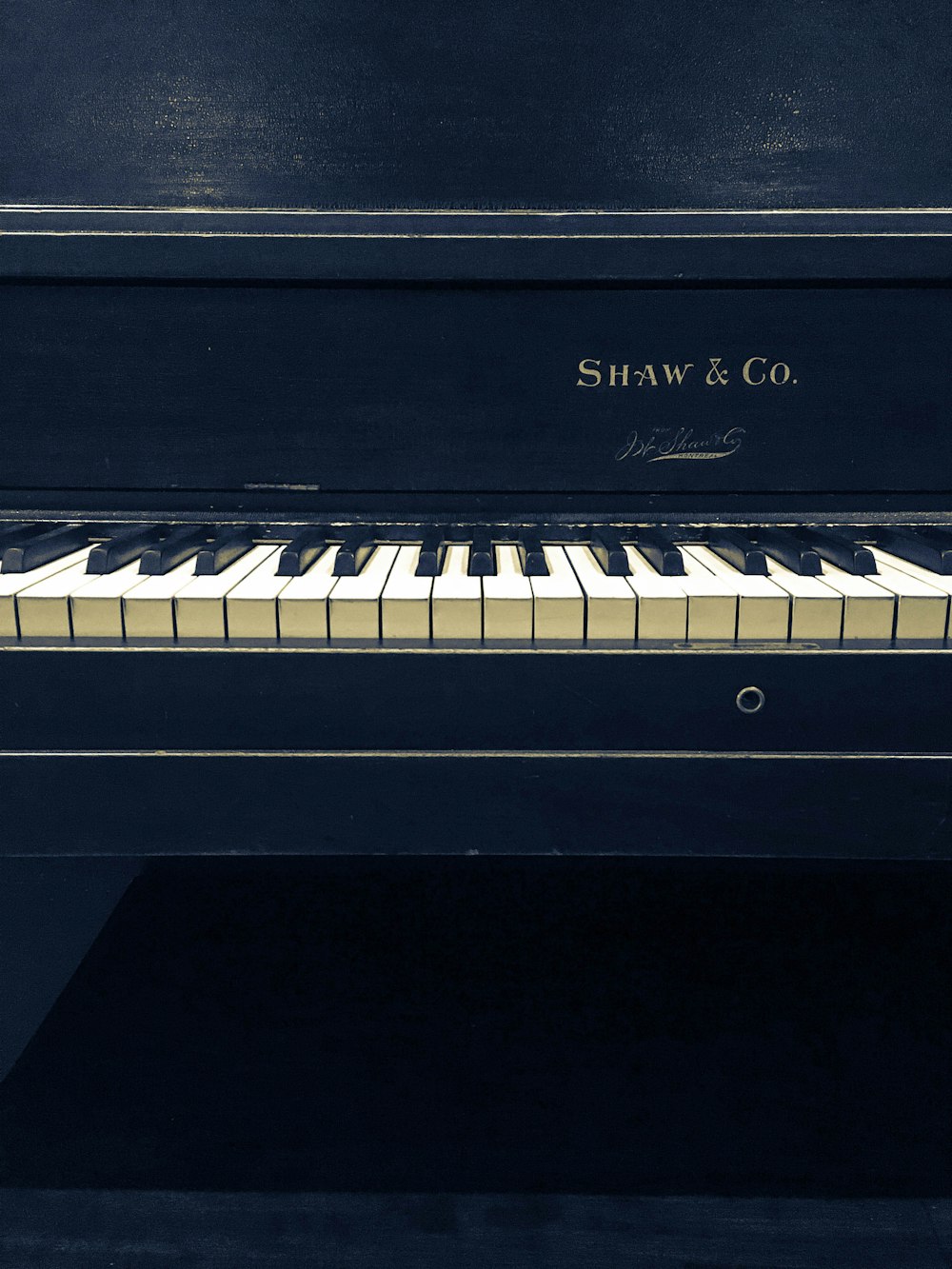 pianoforte verticale Shaw and Co. in bianco e nero