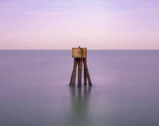 brown wooden sea stand during daytime in Folkestone United Kingdom