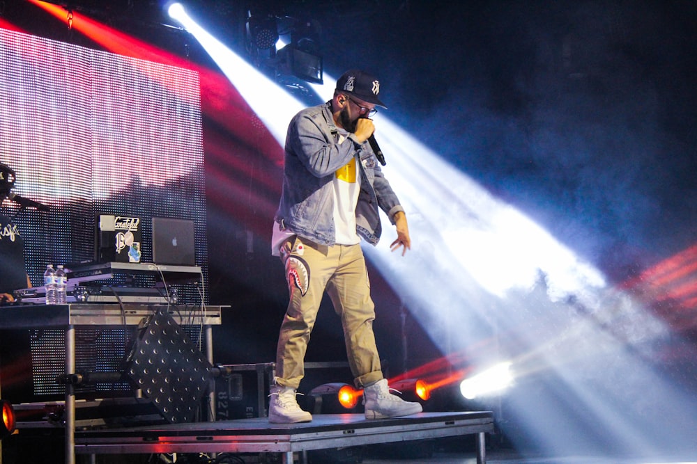 man standing on stage during nighttime