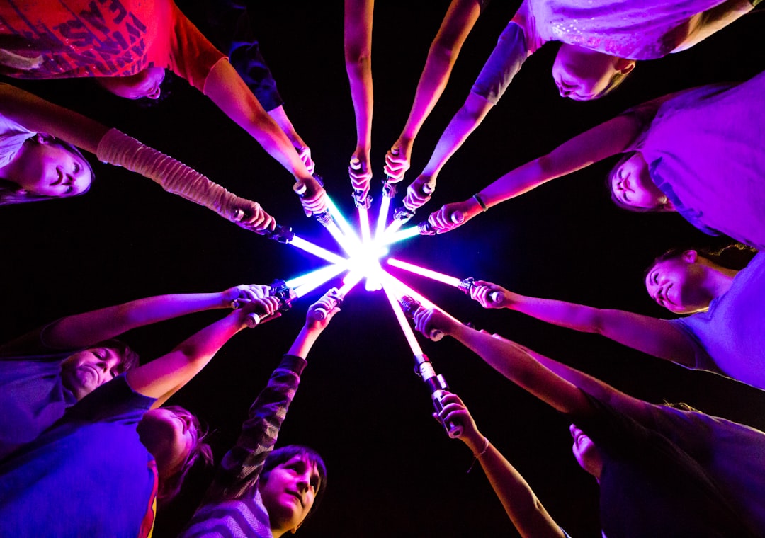 group of people holding light saber