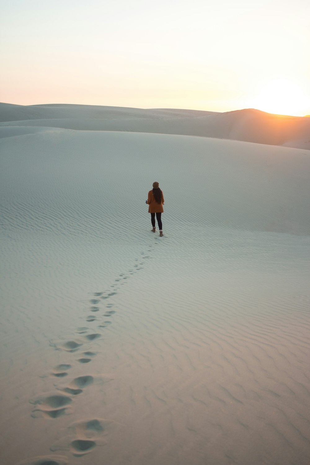 woman walking on dessert during daytime