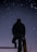 A person stands on a raised platform, gazing at a clear night sky filled with stars. The silhouette of the individual creates a striking contrast against the backdrop of the twinkling celestial bodies.