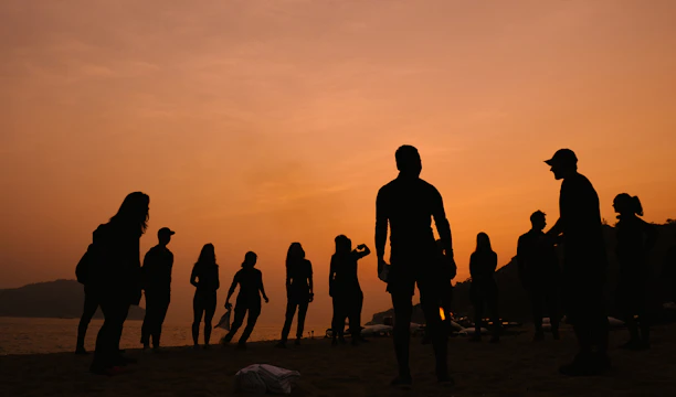 silhouette of people under cloudy sky