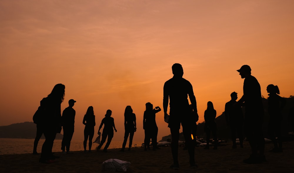 silhouette of people under cloudy sky