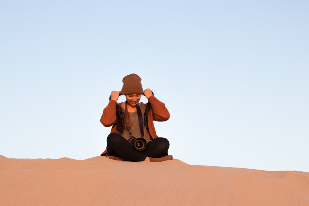 girl sitting on dessert ground