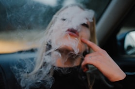 woman smoking in car