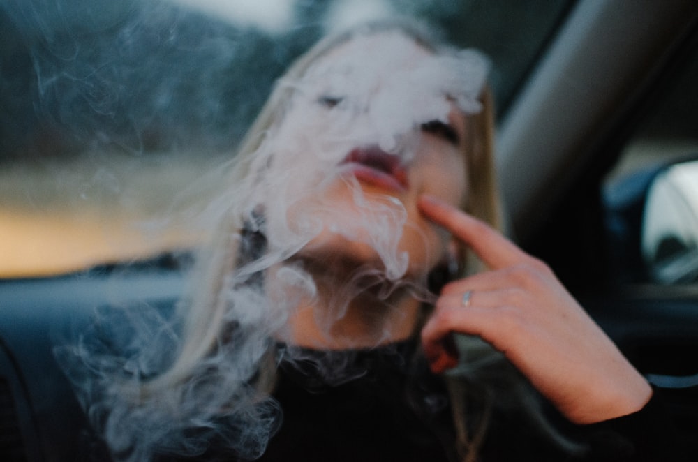 woman smoking in car