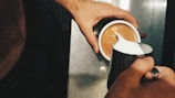 A robotic arm frothing milk for coffee drinks.