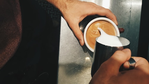 A robotic arm frothing milk for coffee drinks.