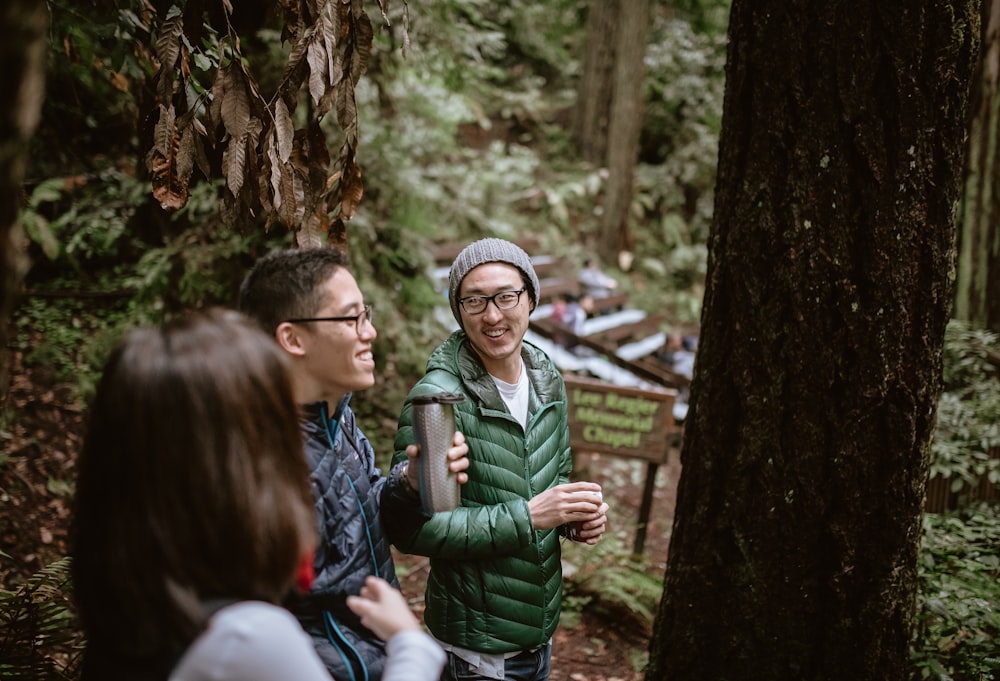 a couple of people that are standing in the woods