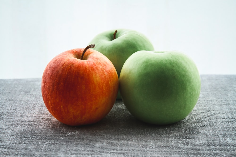 three green and red apple fruits