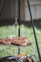 three grilled meat on silver steel grill