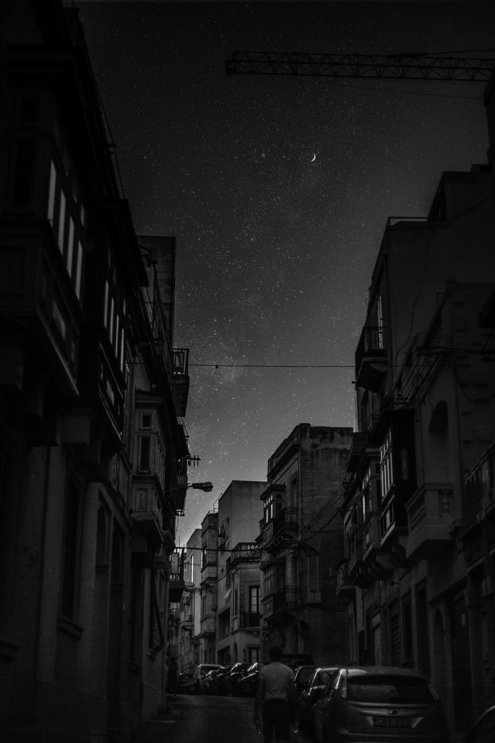 low angle photo of man walking between buildings