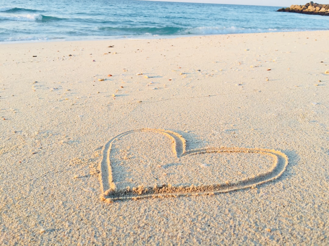 heart drawn on sand during daytime, My YouTube Channel ⟹ https://www.youtube.com/c/knowITbyKhadeeja<p></figure>Walking along the esplanade of Hamriyah Beach, I decided to do something creative and picked up a stick in order to draw a heart into the sand. I immediately clicked a picture of it, as the nature surrounding it was beautiful and soothing.