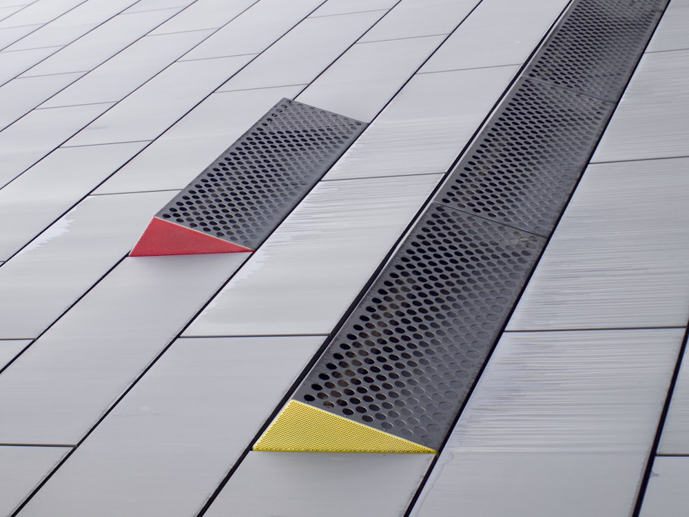 a red and yellow object on a white surface