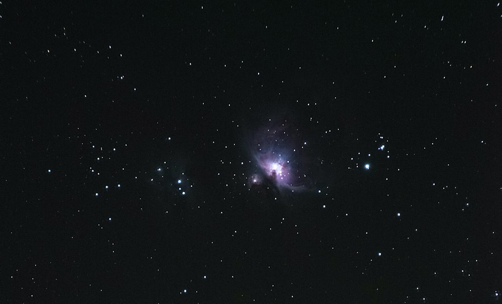 a star cluster in the middle of a night sky