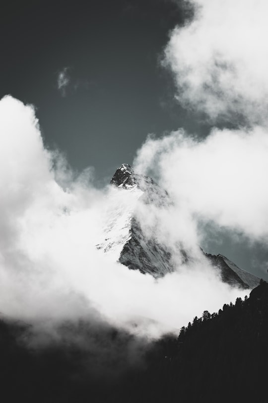 grayscale photo of mountain covered in clouds in Matterhorn Glacier Switzerland