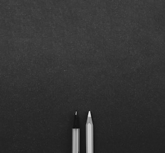 a pen sitting on top of a black surface