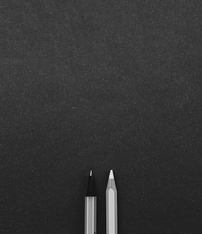 a pen sitting on top of a black surface