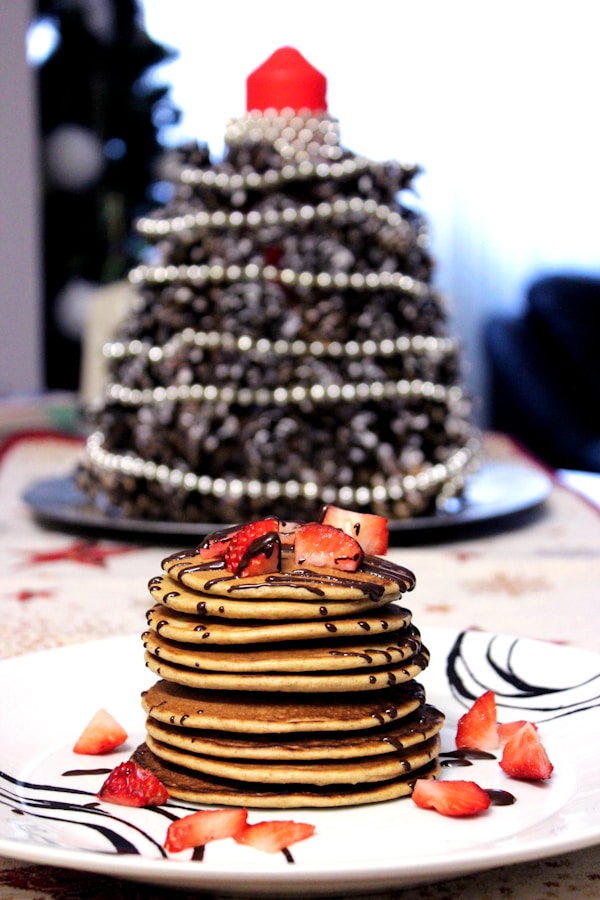 Pancakes with chocolate syrup and strawberry toppings