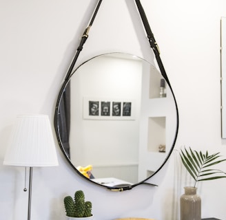 round mirror with black strap