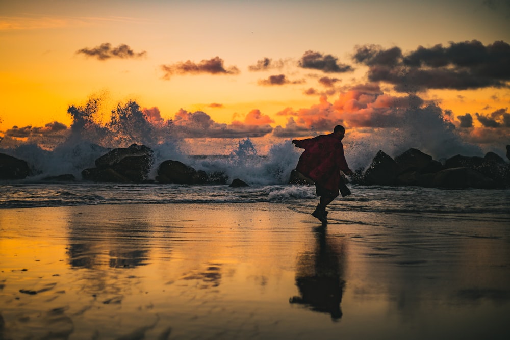 man standing beside seashore