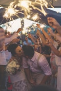 newly wed kissing surrounded by people