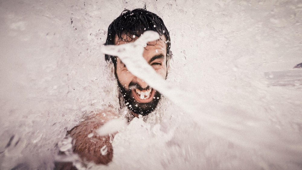 man playing water closeup photography