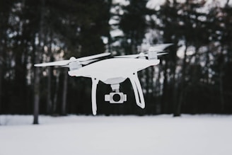 flying quadcopter drone near trees during winter