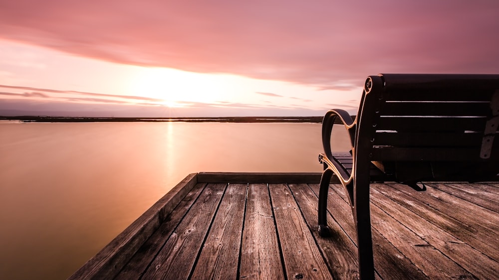 brown bench on wooden dock