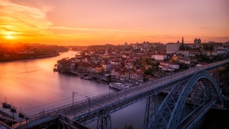 gray bridge near building at sunset in Portugal