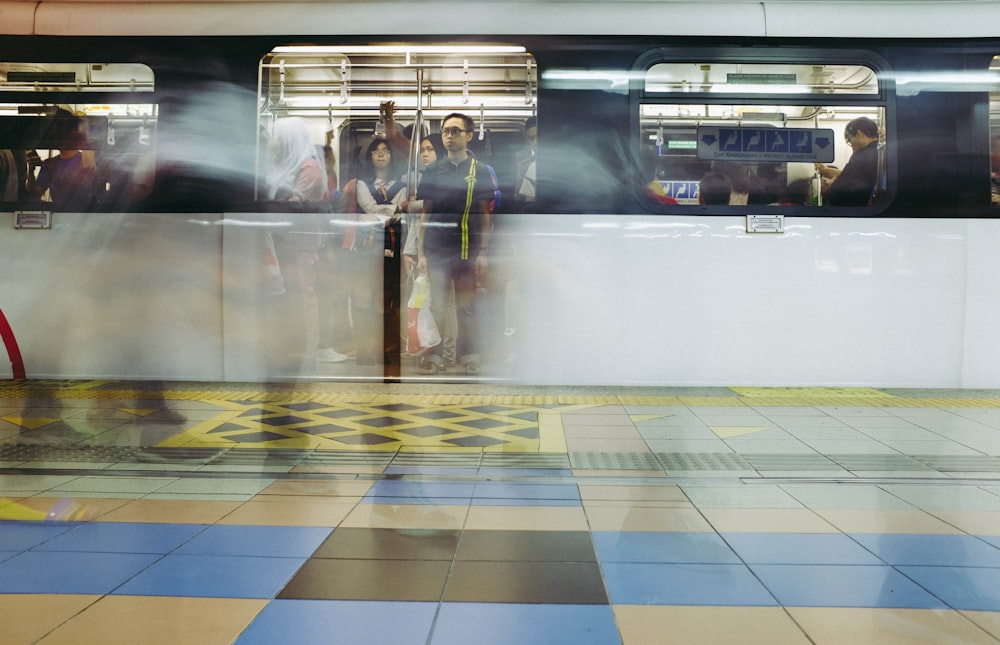 a group of people standing on a subway platform