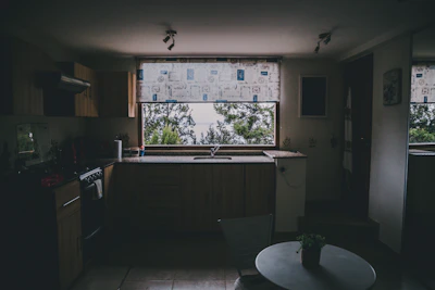 Kitchen space before update with basic cabinetry and limited natural light.