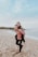 man carrying woman beside seashore