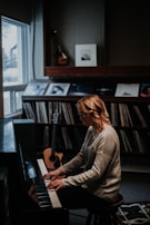 A smiling adult student practicing piano in a cozy room.