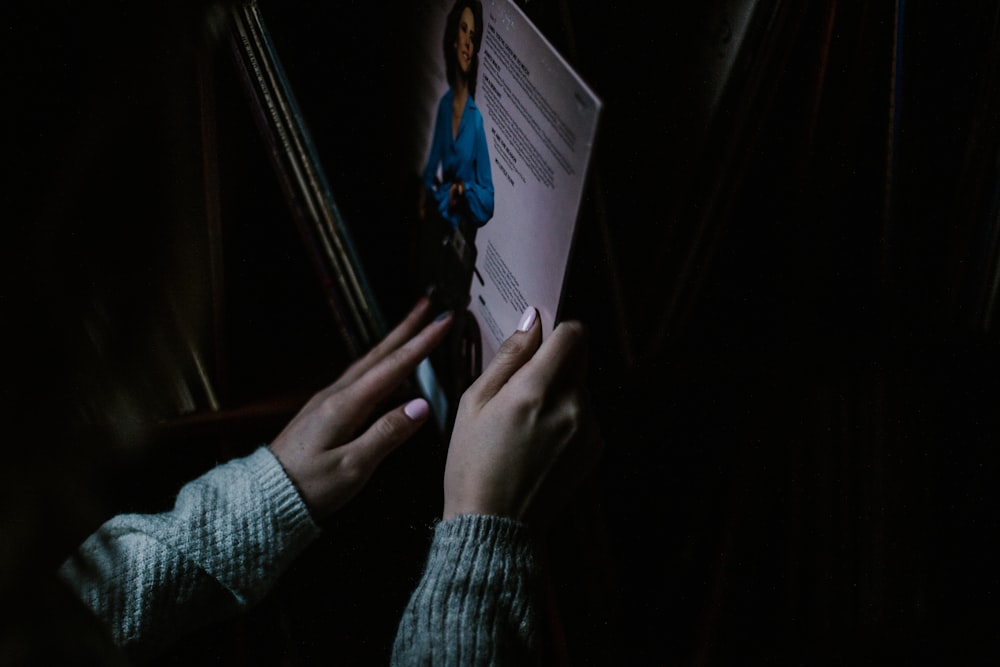 a person reading a book in the dark