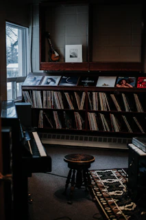 Cozy lounge area with vintage records and comfy chairs where artists relax between sessions.