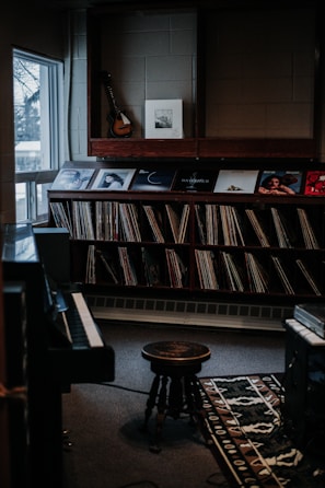 A cozy room with a laptop streaming music and vinyl records scattered around.