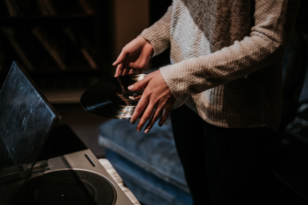 person holding black vinyl record