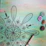 Close-up of a hand-painted mandala with intricate dot work in moss green and gold tones.
