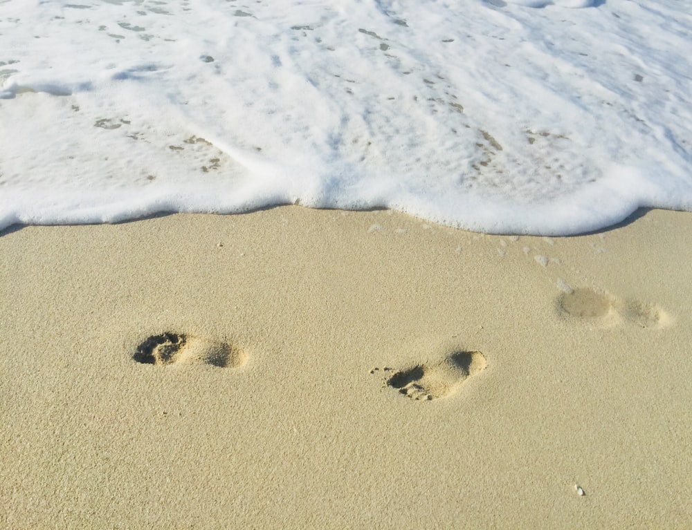 footprints on sand during daytime