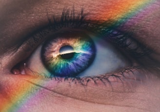 close up photography of rainbow rays on eye