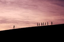 silhouette of people on hill