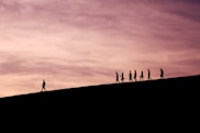 silhouette of people on hill