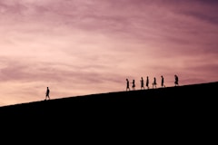 silhouette of people on hill