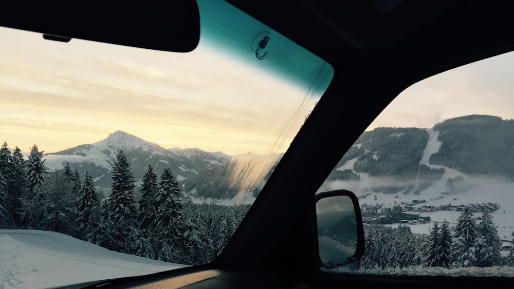 a view from inside a car of a snowy mountain