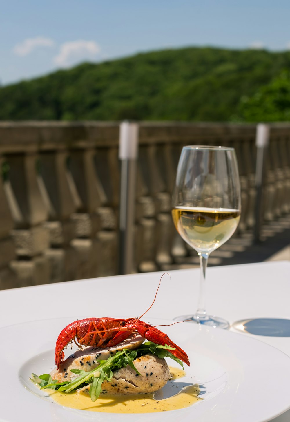 cooked food on white ceramic plate beside glass of champagne