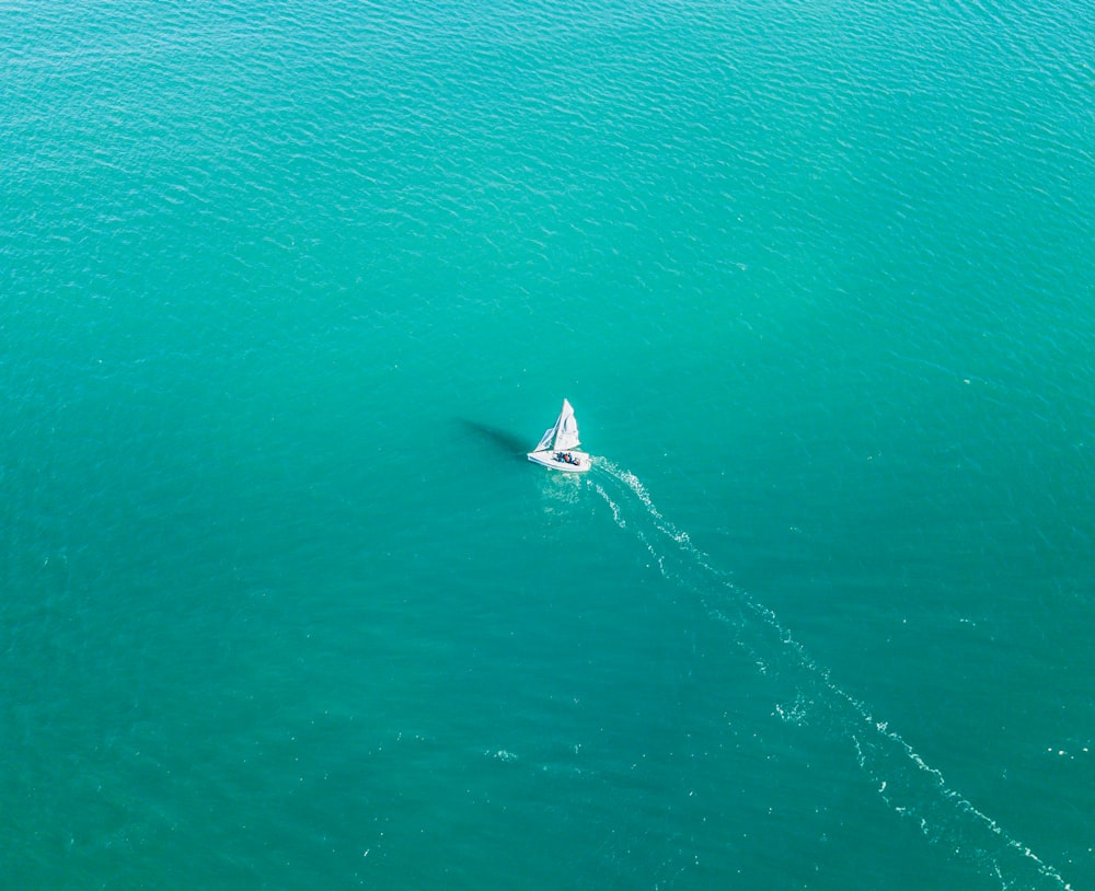 a small boat in the middle of a large body of water