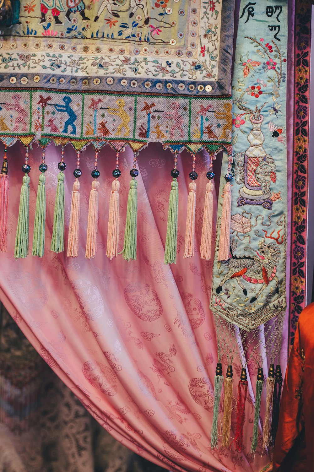 green and multicolored fabric with fringes