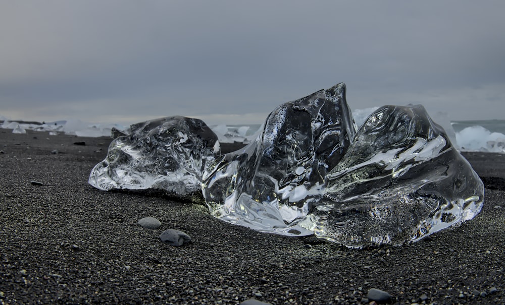 three ice blocks on seashore